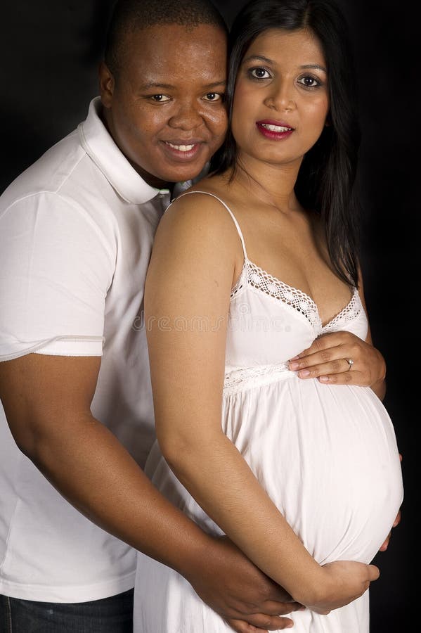 Beautiful pregnant Indian woman and african man