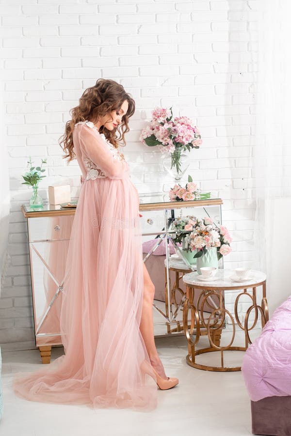 Beautiful Pregnant Lady in a Pink Dress at Home Stock Image - Image of ...