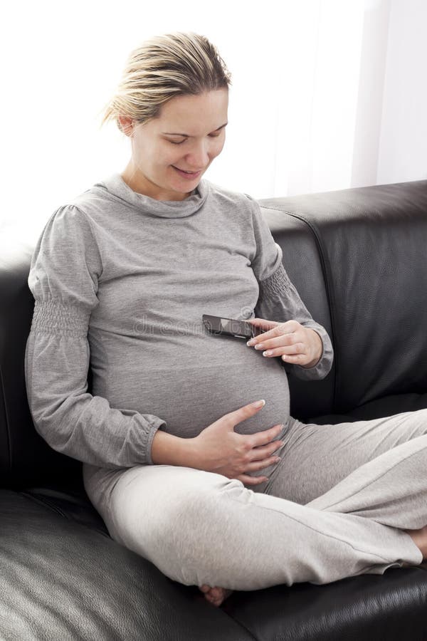 Beautiful pregnant woman on the phone. Beautiful pregnant woman on the phone.