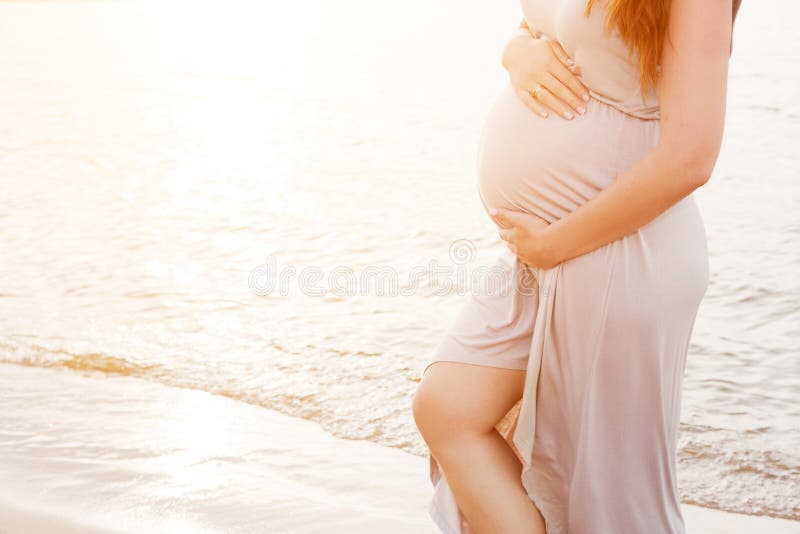 A beautiful pregnant woman on the beach