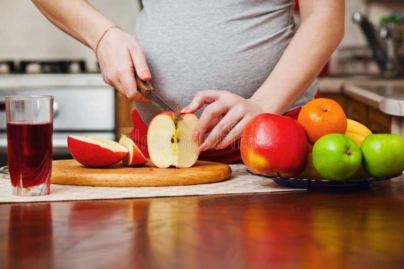 Beautiful pregnant woman on kitchen