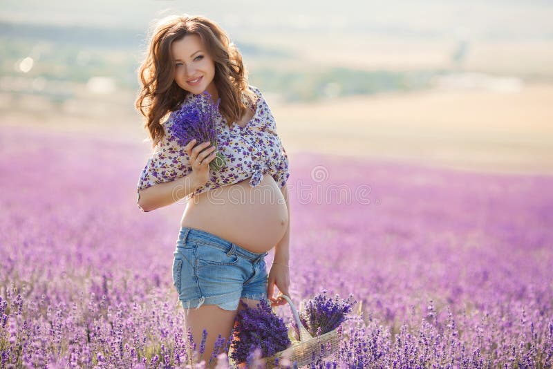 Beautiful pregnant woman in the lavender field.