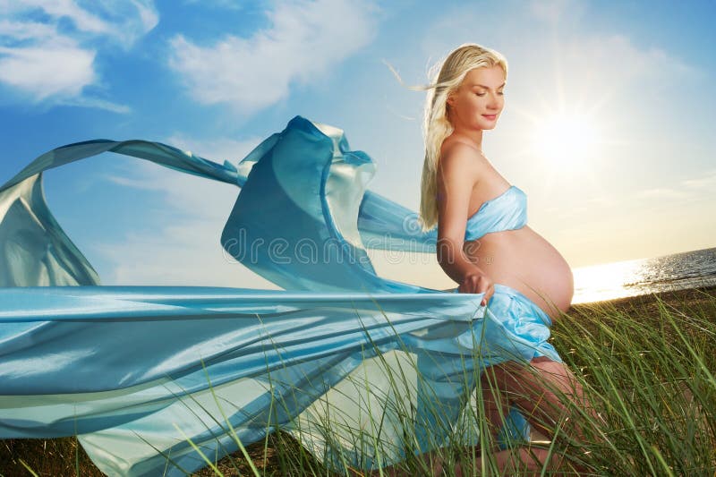 Beautiful pregnant woman outdoors