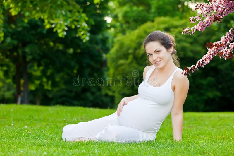 Beautiful pregnant woman in the spring park royalty free stock image Beautiful pregnant woman in the spring park royalty free stock image