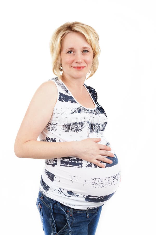 Beautiful pregnant woman tenderly holding her tummy