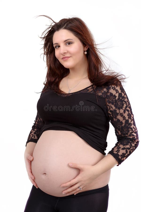 Beautiful pregnant woman tenderly holding her tummy isolated on white background