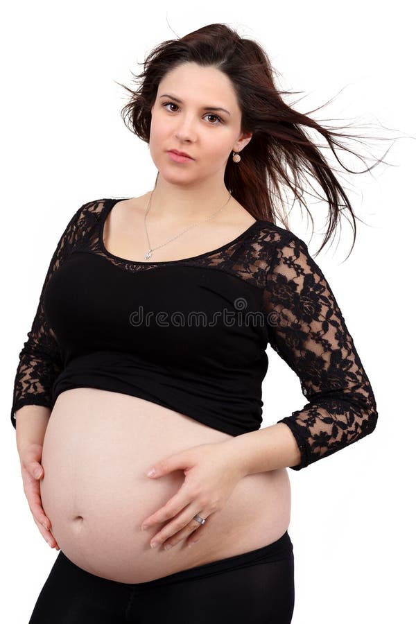 Beautiful pregnant woman tenderly holding her tummy isolated on white background