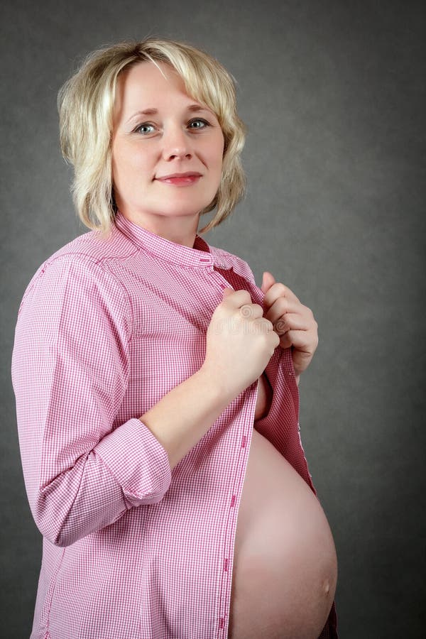 Beautiful pregnant woman tenderly holding her tummy