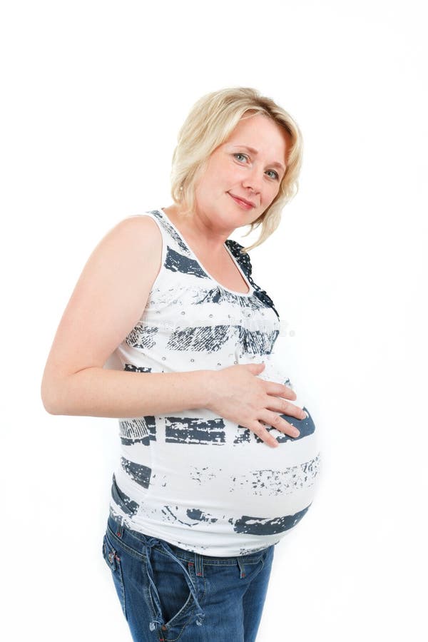 Beautiful pregnant woman tenderly holding her tummy