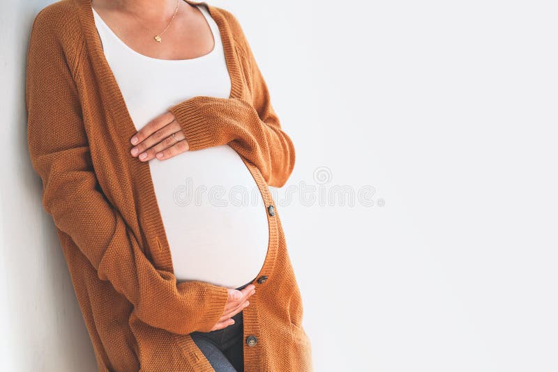 Close-up pregnant woman touching her belly. Mother anticipation