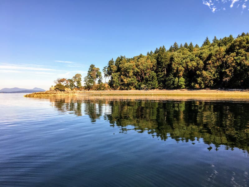 The beautiful pristine Tent Island in the Gulf Islands of British Columbia, Canada. The island reflects of the clear ocean water surrounding it royalty free stock photo The beautiful pristine Tent Island in the Gulf Islands of British Columbia, Canada. The island reflects of the clear ocean water surrounding it royalty free stock photo