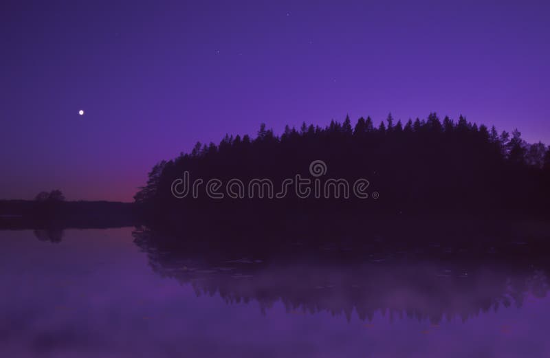 Beautiful purple sunset by lake in summer, with moon shining.