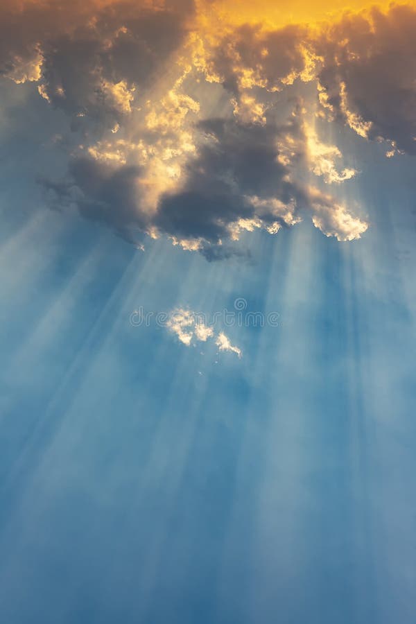 Breaking Through The Clouds 2 Beautiful Ray of Sunlight Breaking through Clouds at Sunset Stock Photo