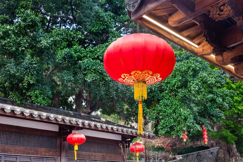 Beautiful red Chinese lantern hanging on eaves of traditional Chinese old style Chinese wood building stock photo Beautiful red Chinese lantern hanging on eaves of traditional Chinese old style Chinese wood building stock photo