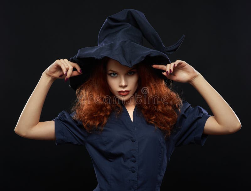 Beautiful red-haired girl in a costume witch