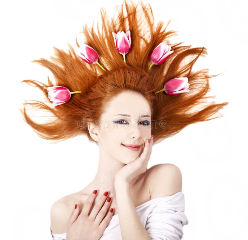 Beautiful red-haired girl with tulips.