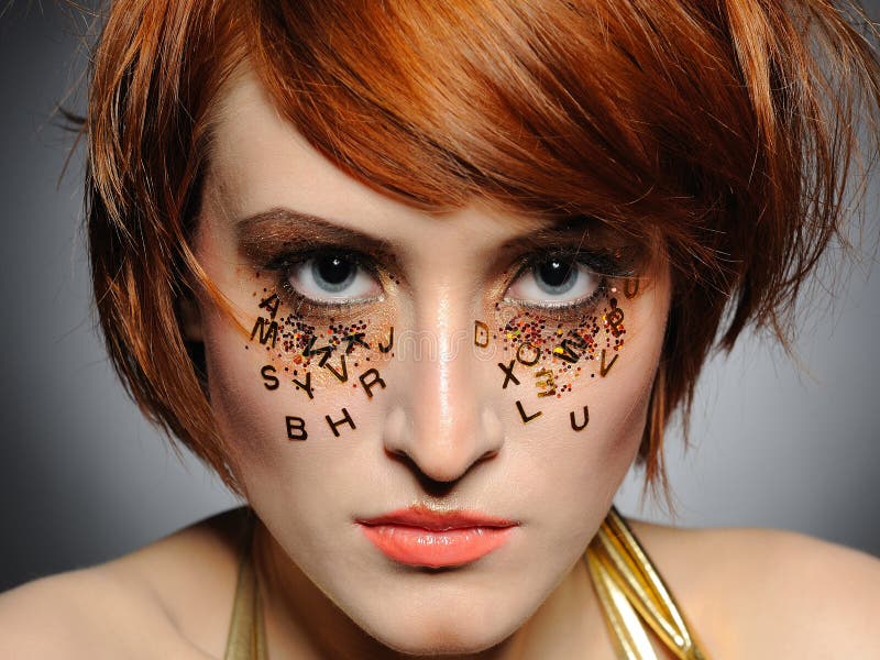 Beautiful red haired woman with creative make-up