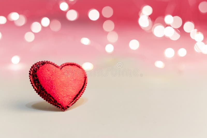 Beautiful red heart on a pink background with lights. Valentines day symbol, love, romance, dating concept with Copy space. Stock royalty free stock image Beautiful red heart on a pink background with lights. Valentines day symbol, love, romance, dating concept with Copy space. Stock royalty free stock image