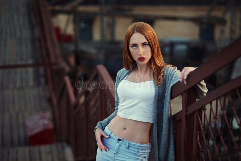 Beautiful redhair young woman in casual closes in urban background. Fashion Photo royalty free stock photos Beautiful redhair young woman in casual closes in urban background. Fashion Photo royalty free stock photos