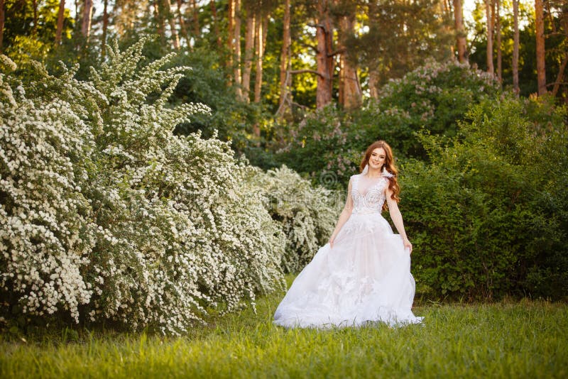 Beautiful Redhead Bride in Fantastic Wedding Dress in Blooming Garden ...