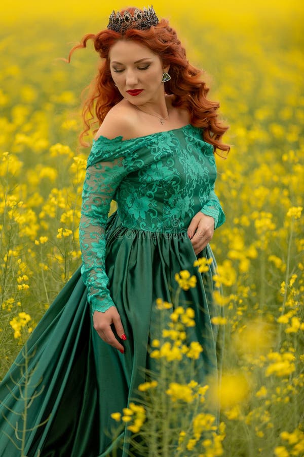 Beautiful Redhead Female Model in a Field of Yellow Rapeseed Flowers ...