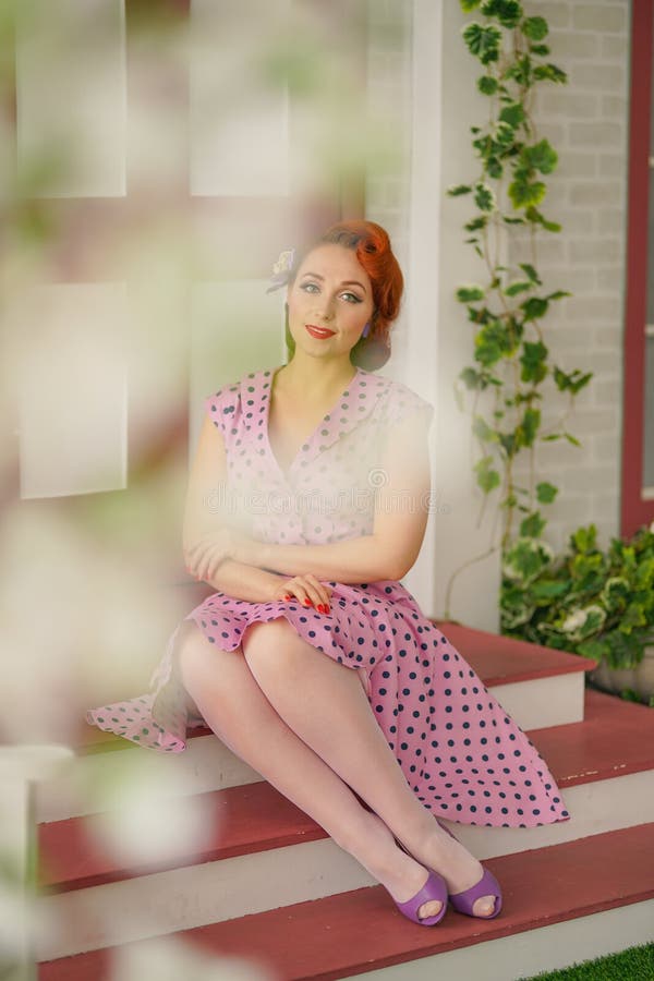 Beautiful Redheaded Pin Up Girl In Pink Polka Dot Dress And Vintage