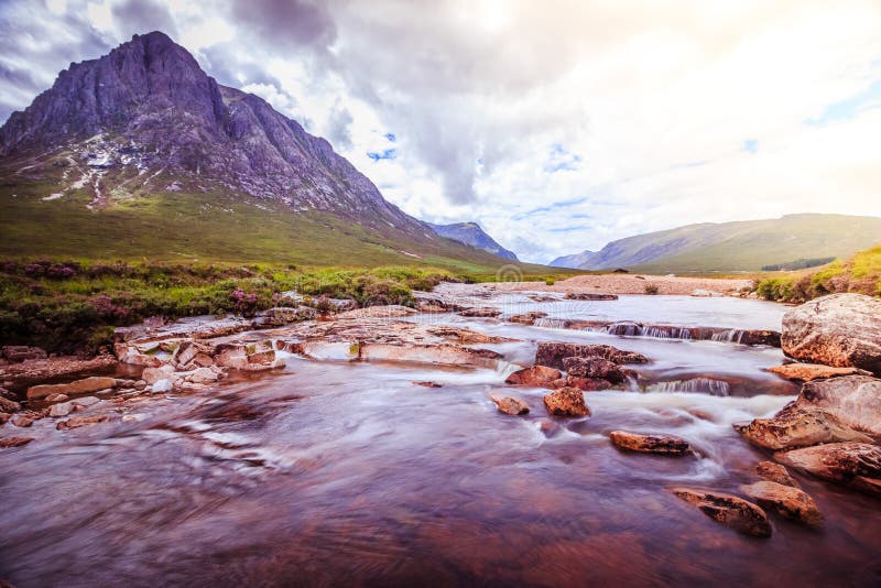 Beautiful river mountain landscape scenery in Glen Coe, Scottish Highlands, Scotland. Sunshine