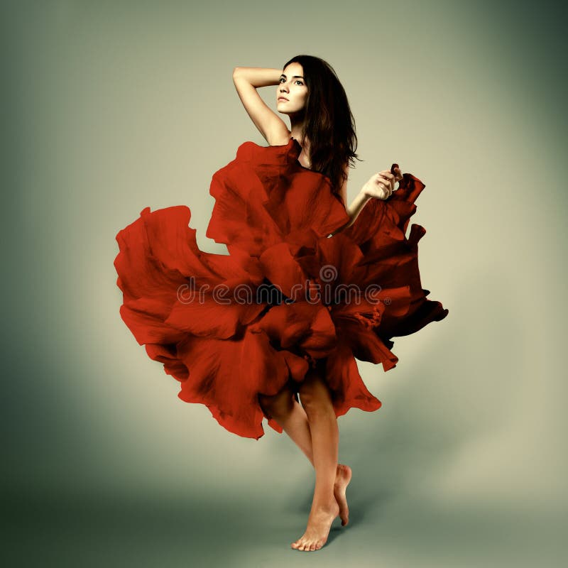 Beautiful romantic girl in red flower dress with long broun hair