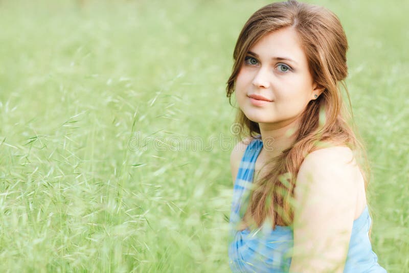 Beautiful romantic girl sitting on field of spikelets and enjoying nature, young elegant woman walking royalty free stock image Beautiful romantic girl sitting on field of spikelets and enjoying nature, young elegant woman walking royalty free stock image
