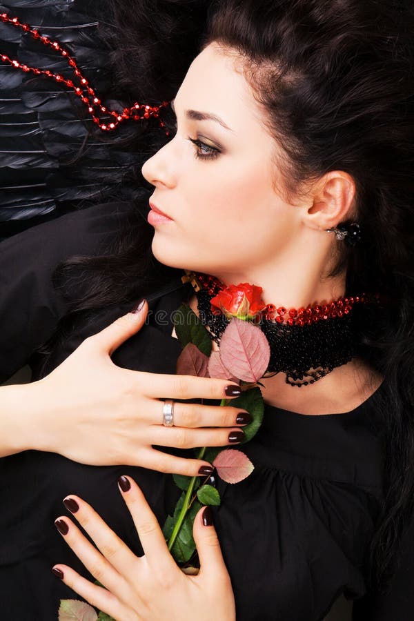 Beautiful romantic woman with a red rose