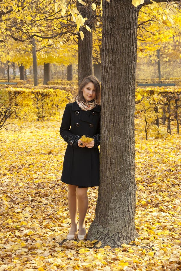 Beautiful romantic young girl in an autumn park