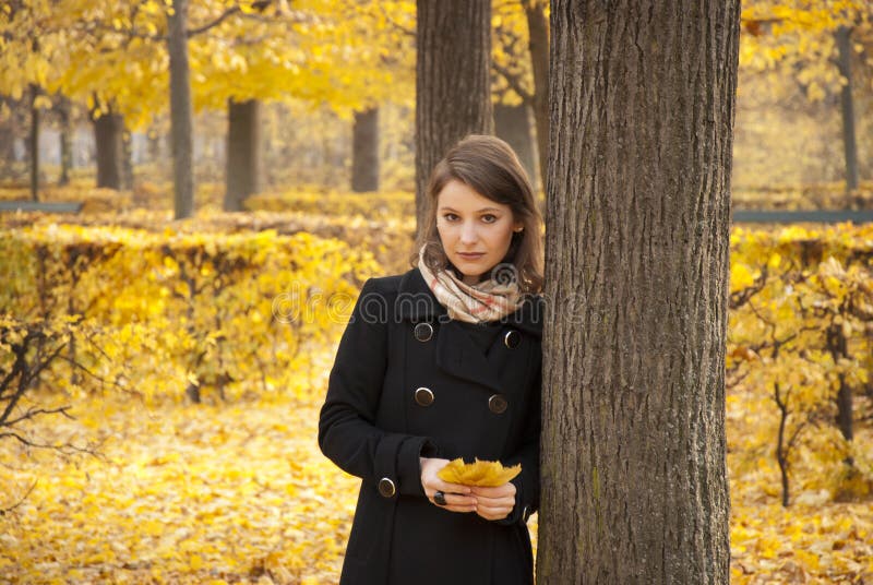 Beautiful romantic young girl in an autumn park