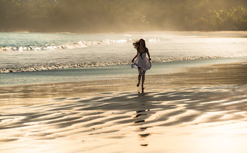 Naked girl running in water