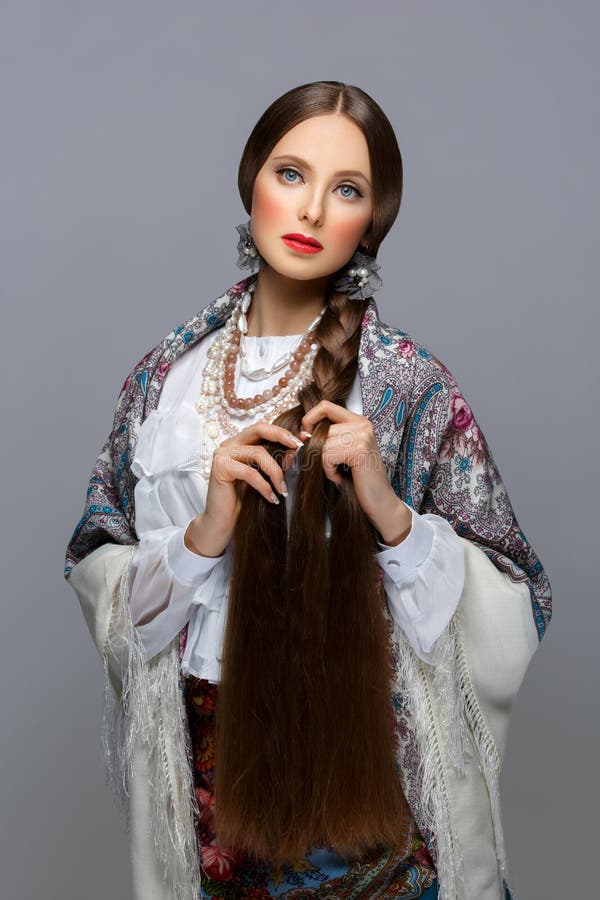 beautiful-russian-girl-young-woman-very-long-braid-traditional-shawl-red-lips-over-grey-background-72157675.jpg