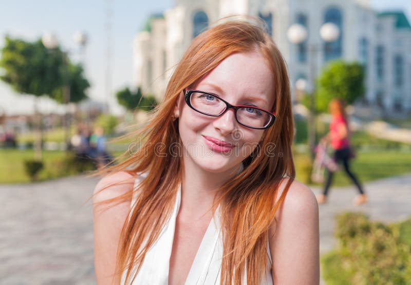 Beautiful 20s aged redhead smiling woman outdoors