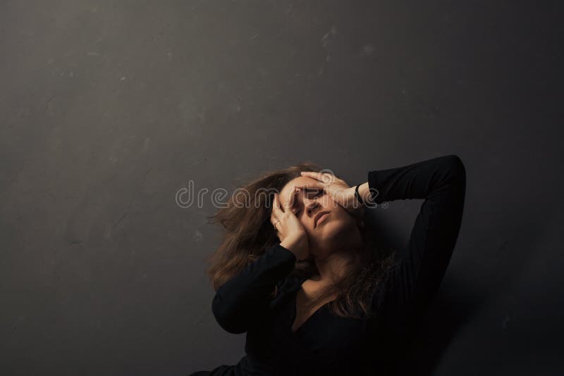 Beautiful Sad Young Woman Holding Hands on Her Face on a Dark ...