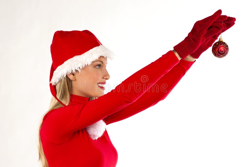 Beautiful Santa girl holding a Christmas ball