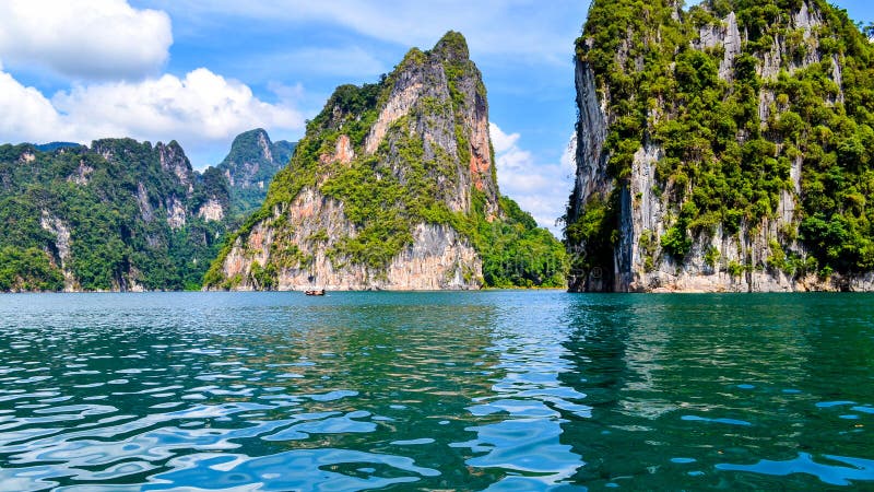 Beautiful scene Blue clear water with rock mountain .