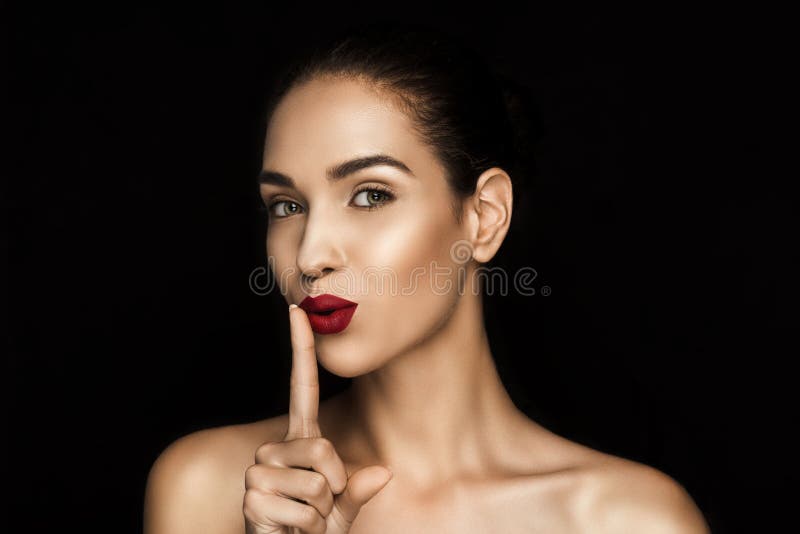 Beautiful seductive woman with shh symbol