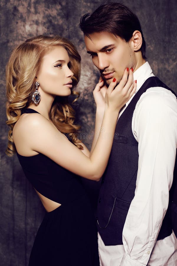 Beautiful sensual couple in elegant clothes posing in studio stock image Beautiful sensual couple in elegant clothes posing in studio stock image