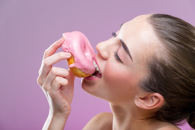 Beautiful sensual woman, eat a donut.