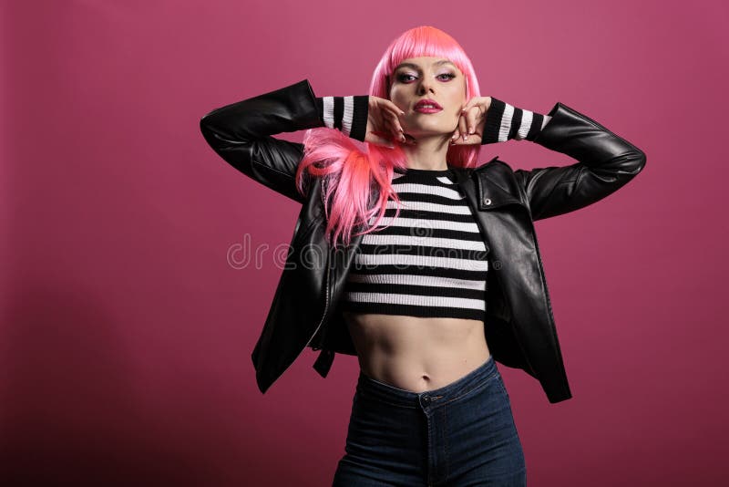 Beautiful sensual woman with pink hair wearing punk leather jacket