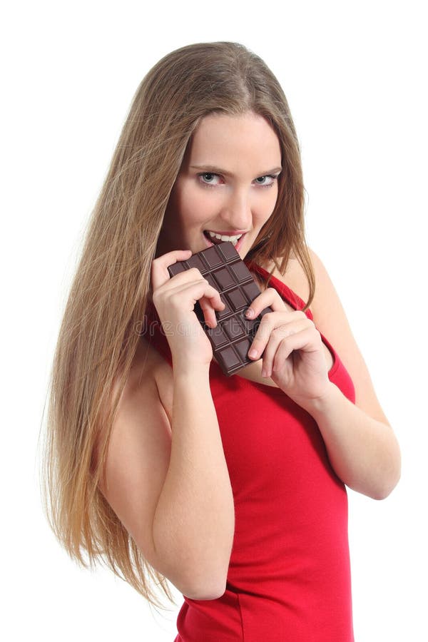 Beautiful woman in red eating a chocolate bar stock photo Beautiful woman in red eating a chocolate bar stock photo
