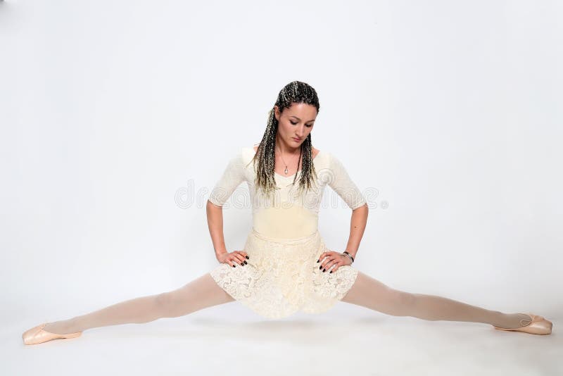 Beautiful, sexy blonde ballerina girl with afro braids posing in studio on isolated background.  Ballet, art, fashion concept.