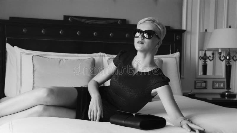 Beautiful Blonde Business Woman Wearing Skinny Short Dress Jewelry Sunglasses Luxury Hotel Bed