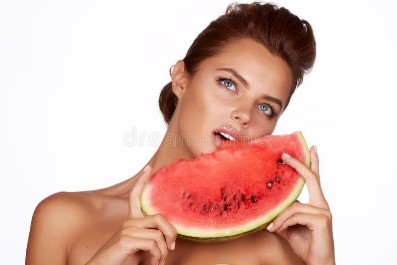 Beautiful brunette woman eating watermelon on a white background, healthy food, tasty food, organic