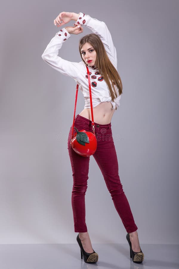 Beautiful brunette woman wear red pants and whie skirt. summer collection clothes, goods bag make a pose fashion stock images Beautiful brunette woman wear red pants and whie skirt. summer collection clothes, goods bag make a pose fashion stock images