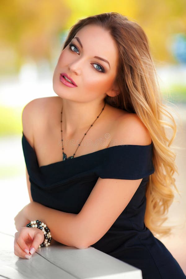 Beautiful woman with black dress and blond hair outdoor. Fashion girl royalty free stock photos Beautiful woman with black dress and blond hair outdoor. Fashion girl royalty free stock photos