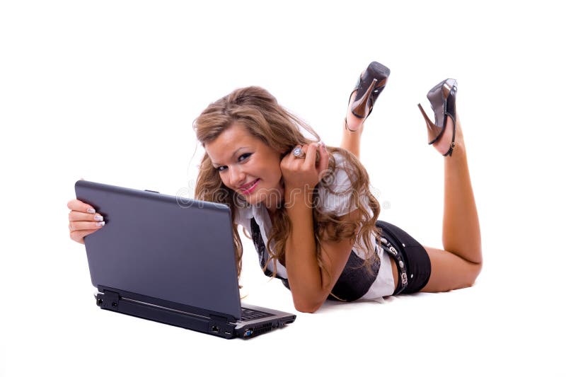 Beautiful woman with a laptop lying on floor.