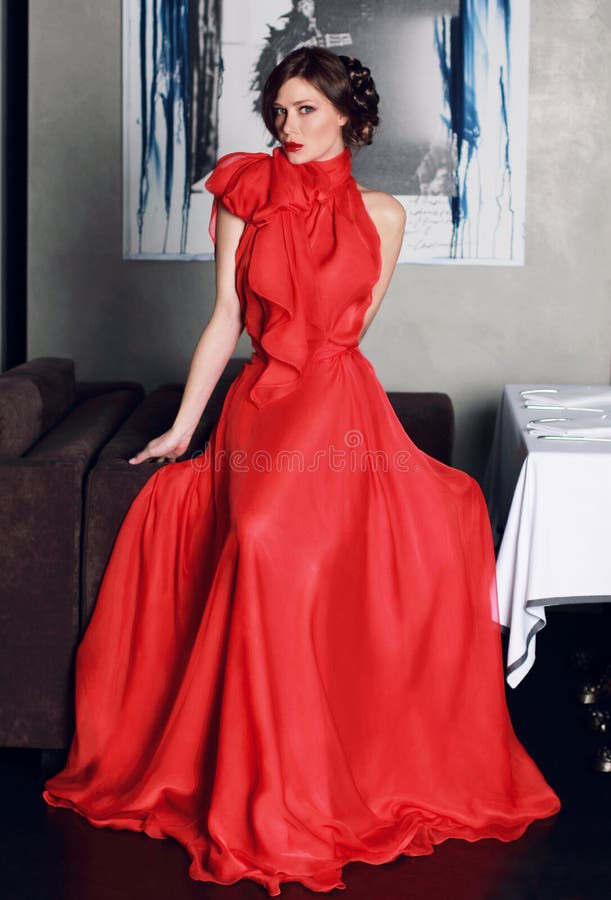 Beautiful woman in red long evening dress of silk